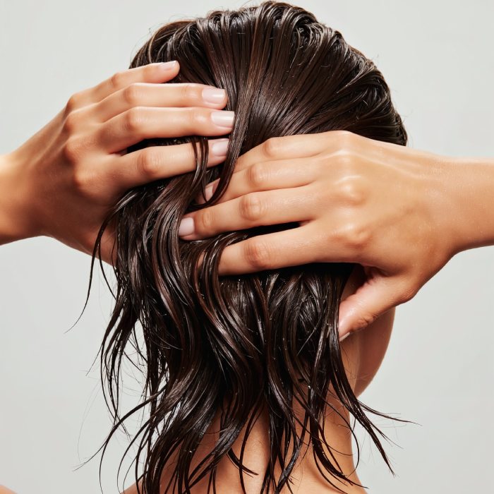 woman with wet hair hands head